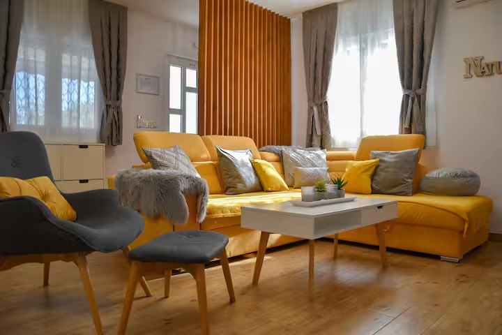 Bright living room with yellow corner sofa